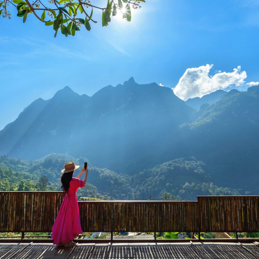 Woman tourist taking photo of Doi Luang Chiang Dao mountains, Chiang mai, Thailand.